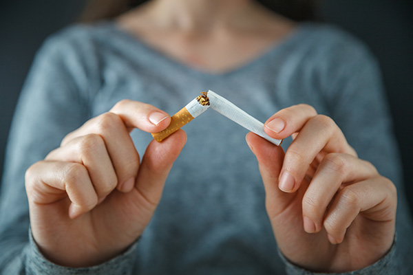 Image of a person discarding a cigarette